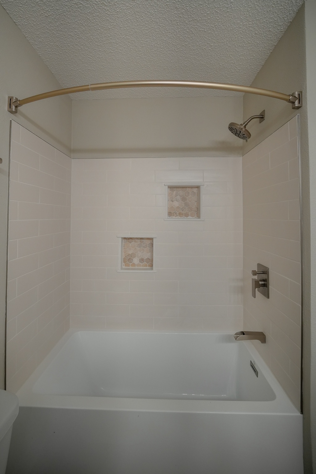After: tiled bath with recessed niches